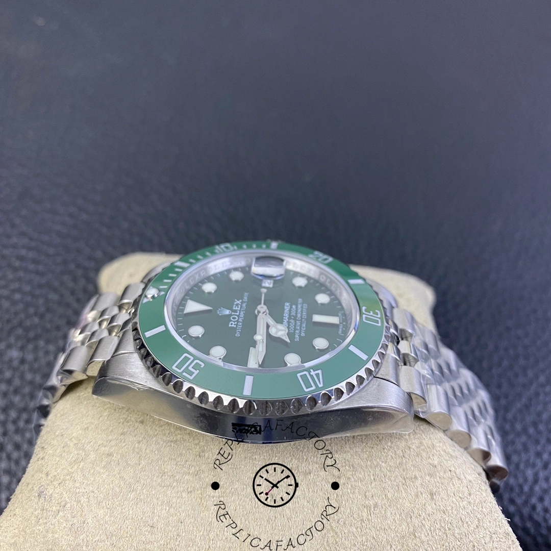 Low angle of Rolex Submariner 116610LV showing green ceramic bezel detail.