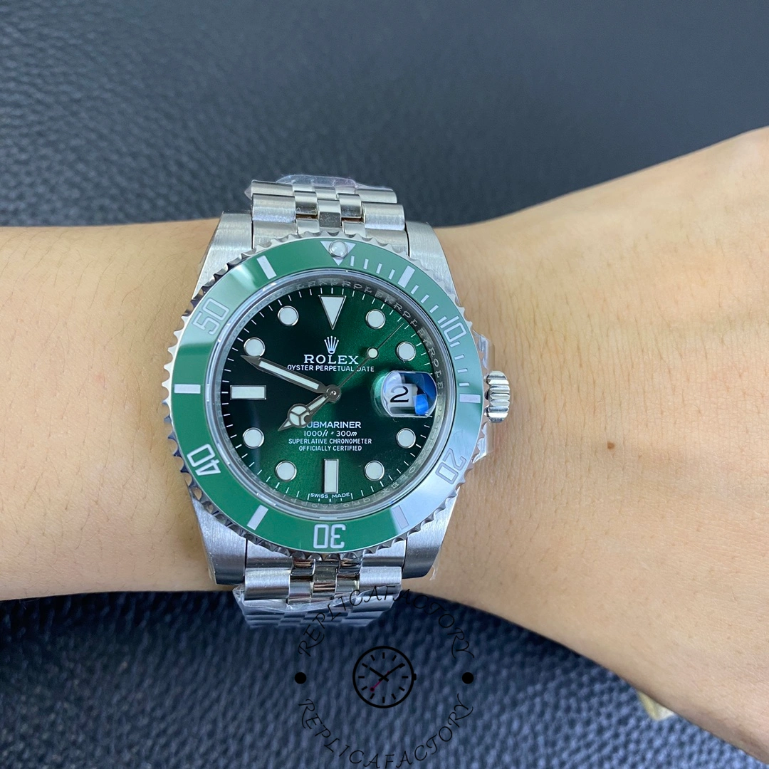 Wrist shot of Rolex Submariner 116610LV with green dial and Jubilee bracelet.