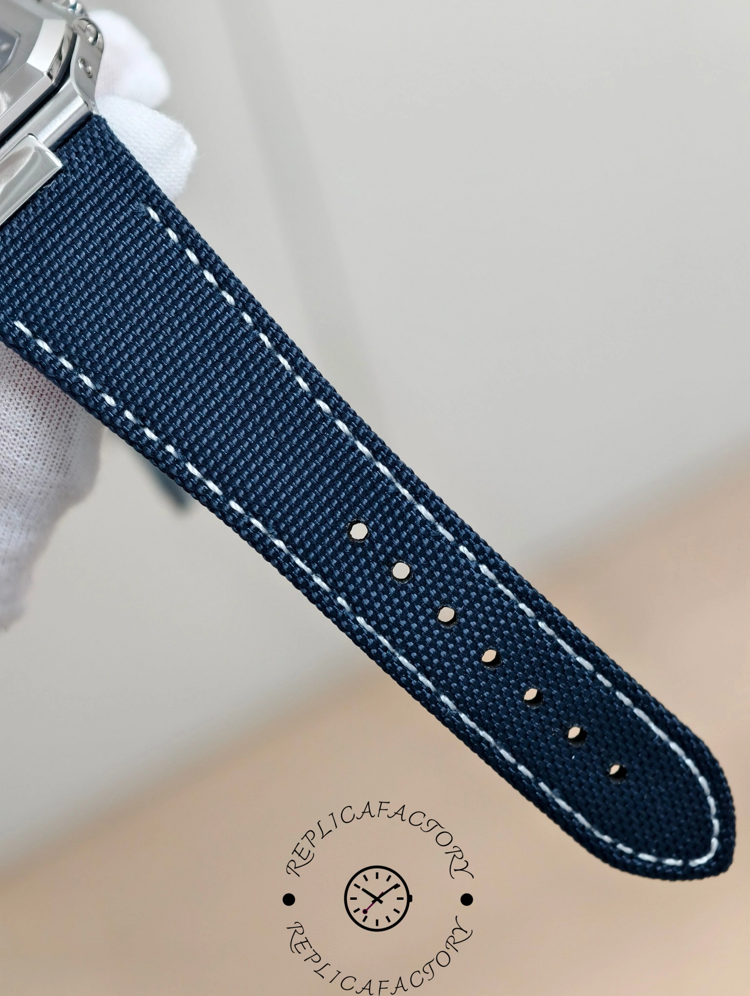 Patek Philippe Cubitus 5822P-001 strap view showing blue stitching and textured surface.