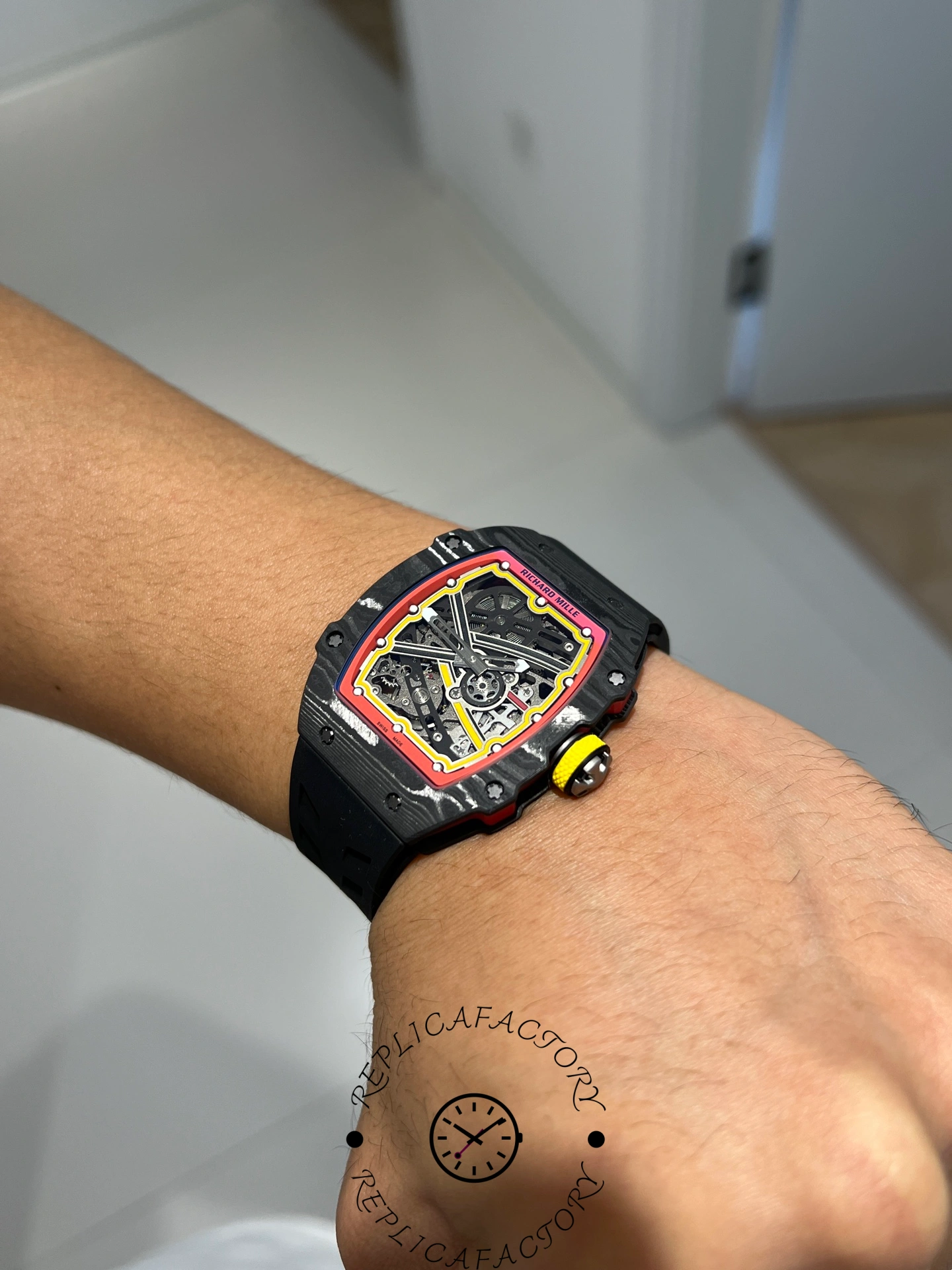 Angled wrist view of Richard Mille RM67-02 showing curved case fit and red bezel details.