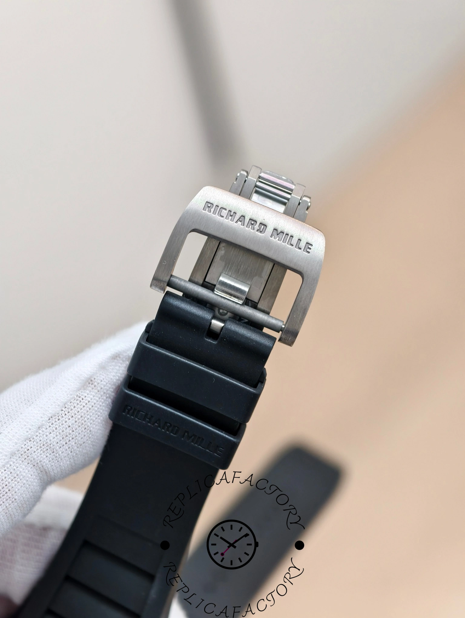 Richard Mille RM 055 RMUL2 clasp close-up showing logo engraving on titanium buckle.