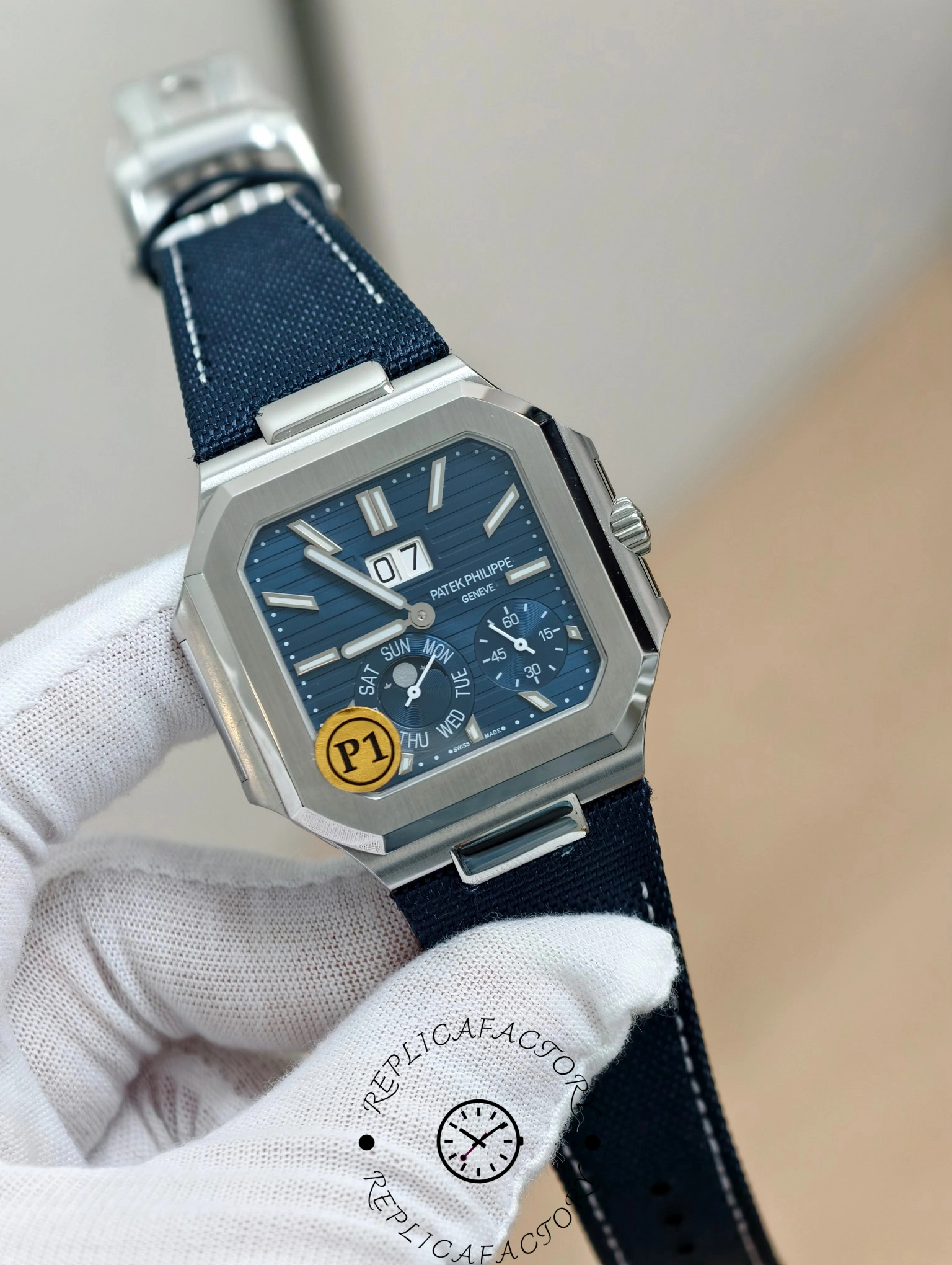 Angled view of Patek Philippe Cubitus 5822P-001 showing brushed bezel and blue fabric strap.