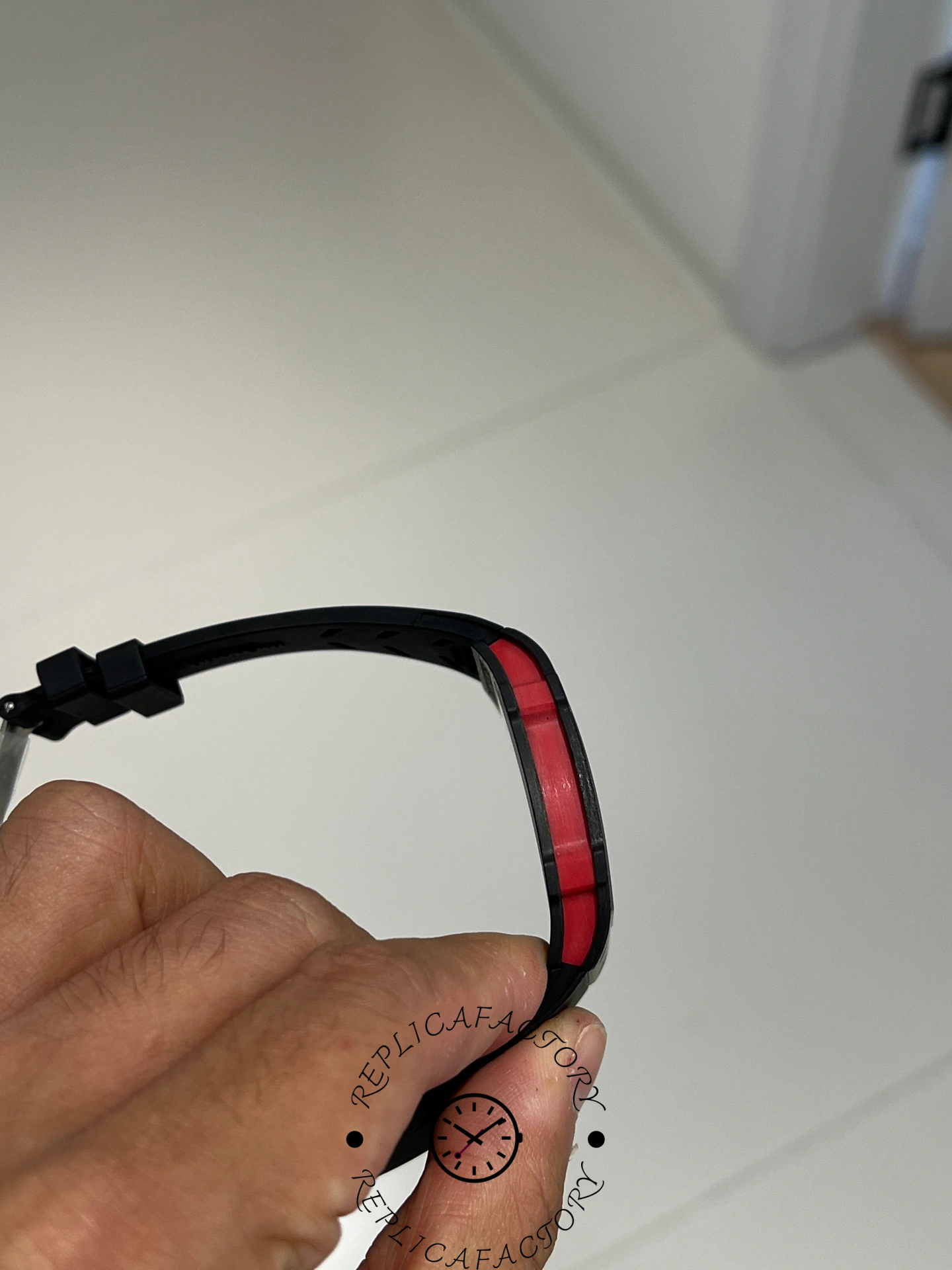 Profile view of Richard Mille RM67-02 case showing red detail band along the edge.