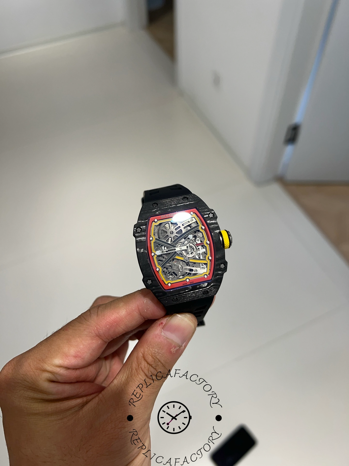 Handheld image of Richard Mille RM67-02 Alexander Zverev showing yellow crown and red accents.