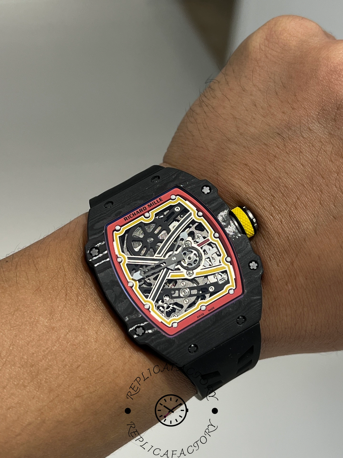Close wrist shot of Richard Mille RM67-02 showing carbon TPT texture and crown detail.