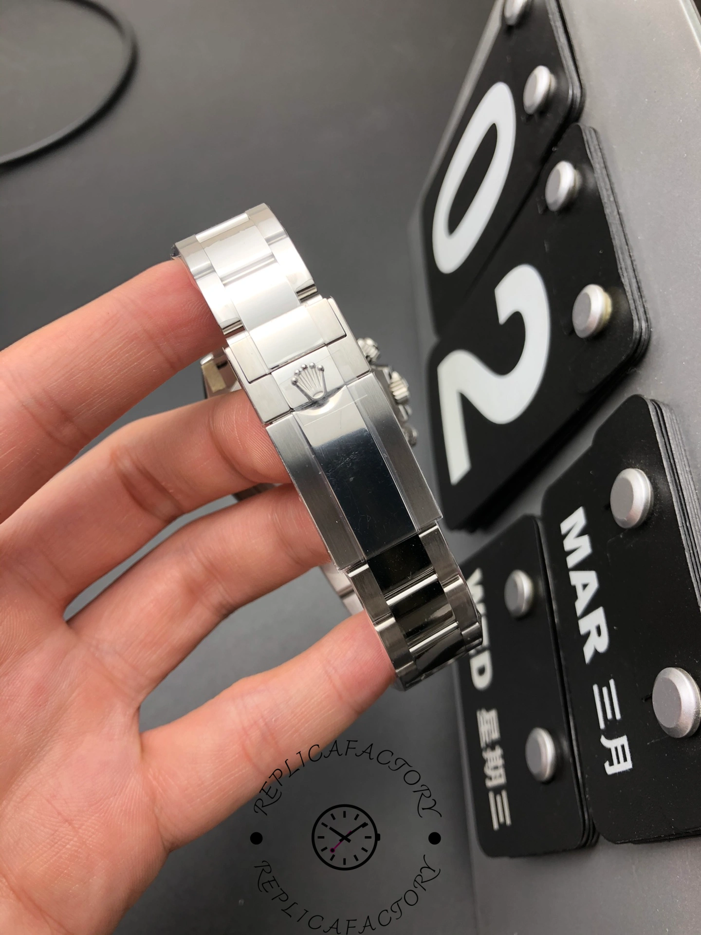 Clasp view of Rolex Daytona 116500LN-0001 showing Rolex crown logo on polished steel.