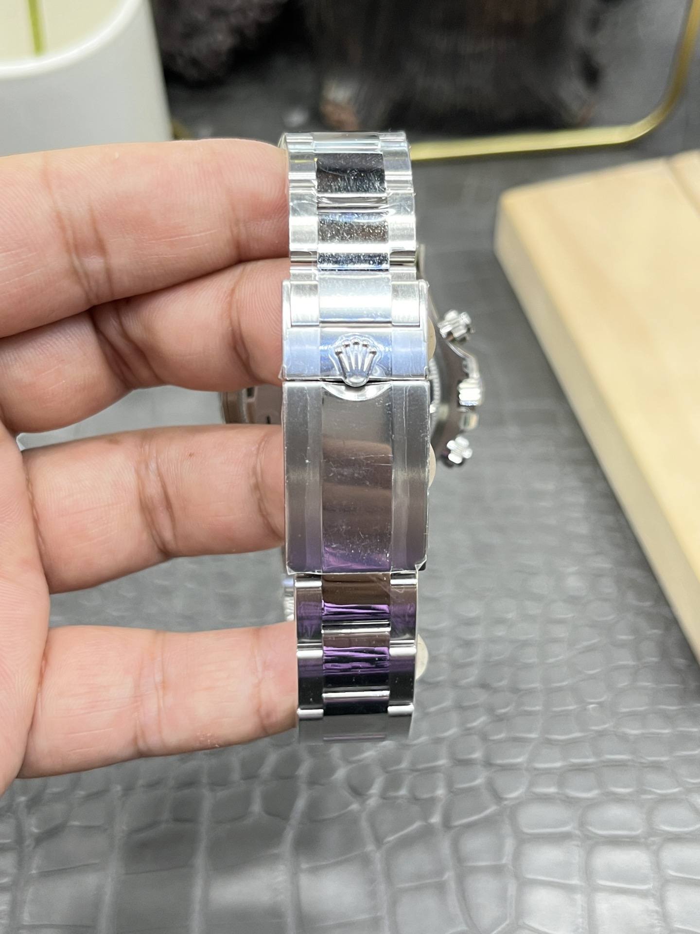 Close-up of the Rolex Cosmograph Daytona M126500LN bracelet clasp showing the engraved logo.