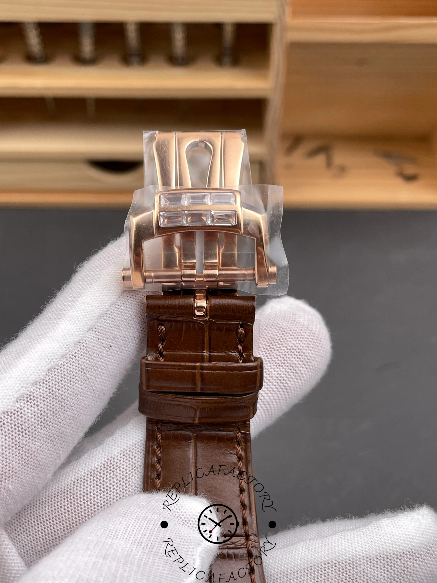 Close-up of Patek Philippe Nautilus 5724/001 clasp showing baguette diamond buckle design.