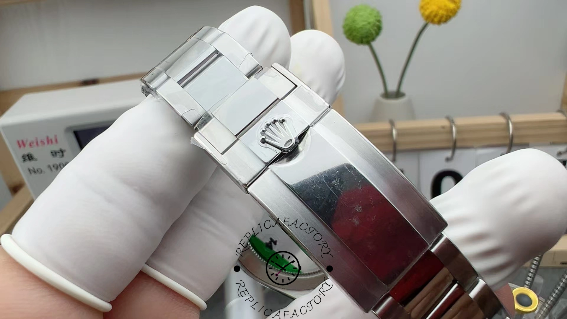 Close-up of the Rolex Cosmograph Daytona 116500LN clasp showing polished surface and raised Rolex crown.