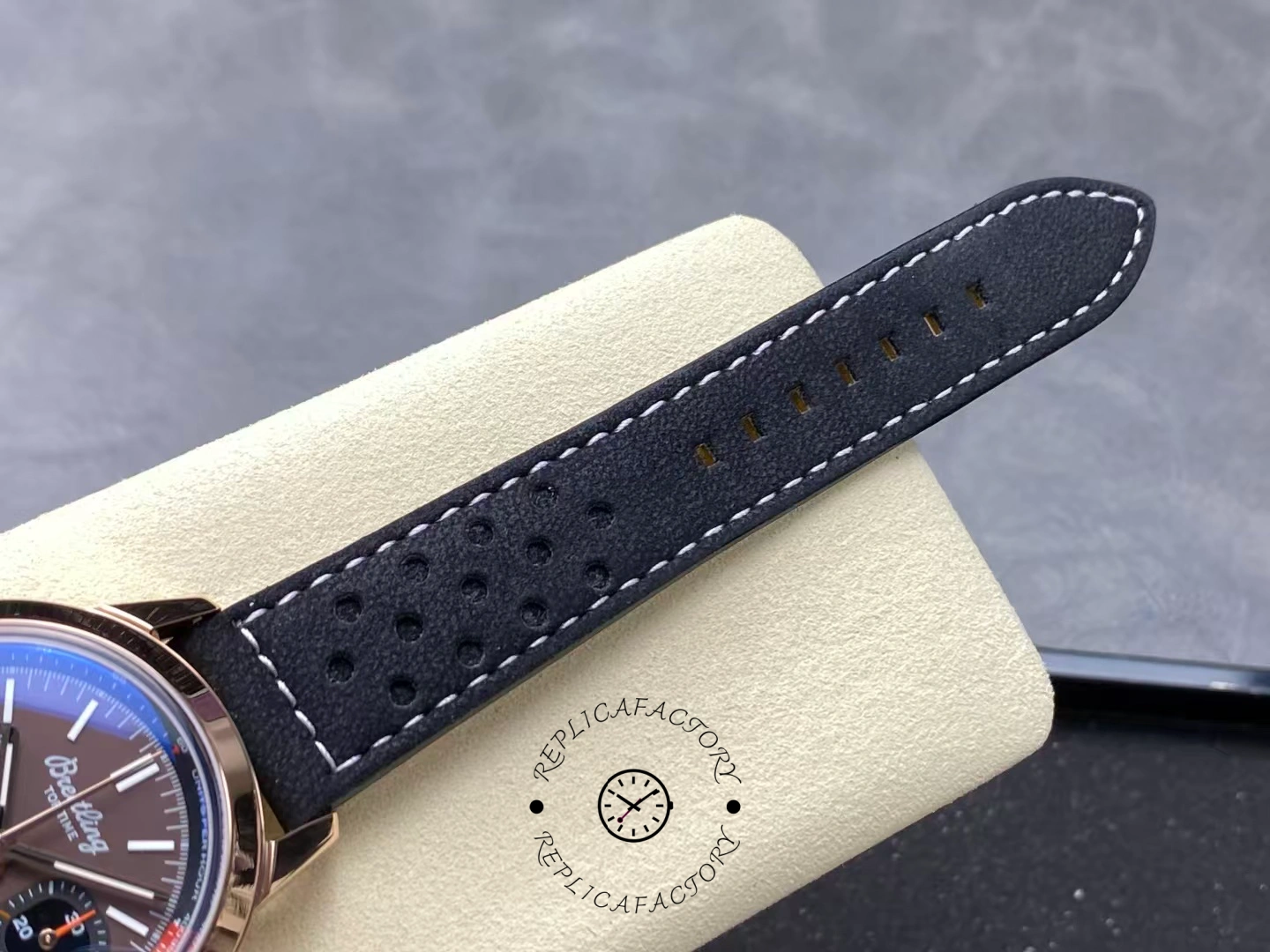 Close-up of black perforated calfskin strap on Breitling Top Time B01 RB01761A1Q1X1.