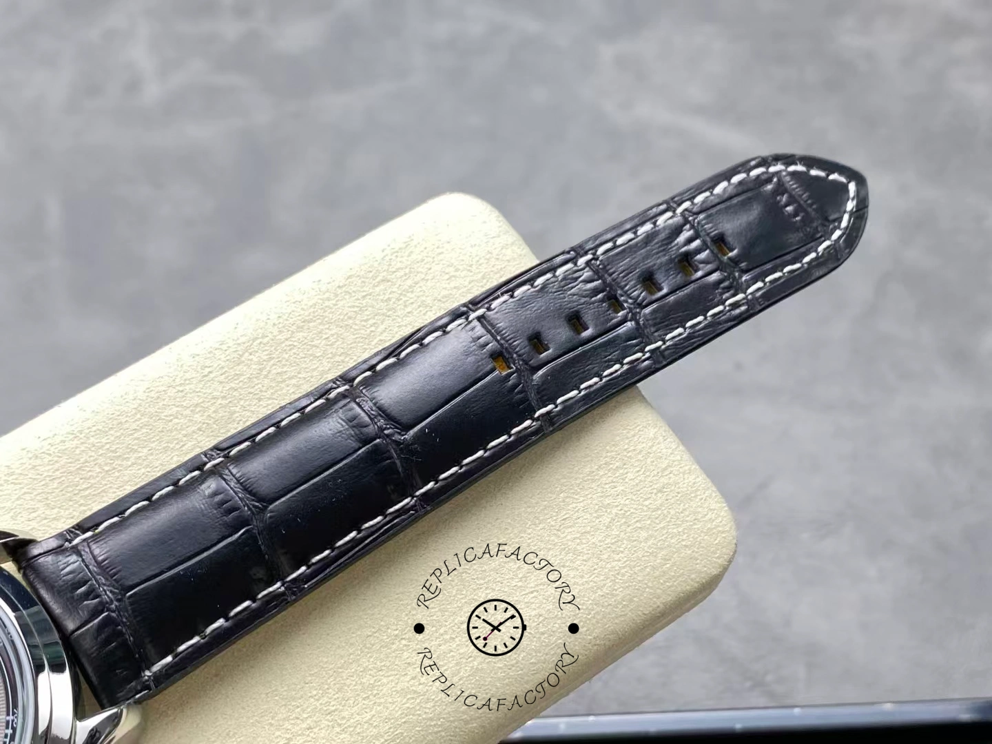 Upper strap detail of Breitling Premier B01 AB0118221B1P2 showing leather stitching texture.