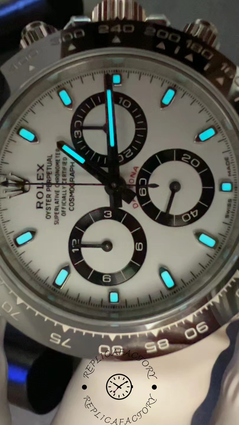 Lume shot of the Rolex Cosmograph Daytona 116500LN in the dark showing blue Chromalight illumination on dial markers.