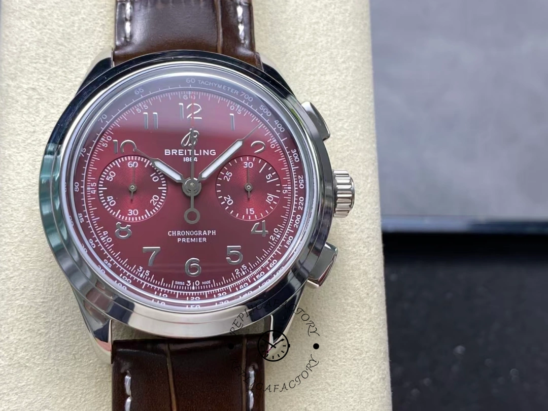 Close-up of burgundy dial on Breitling Premier B09 Chronograph AB0930D41K1P1 with silver hands. - Front view