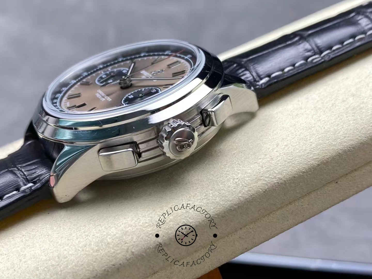 Side view of Breitling Premier B01 AB0118221B1P2 crown and pushers in stainless steel case.