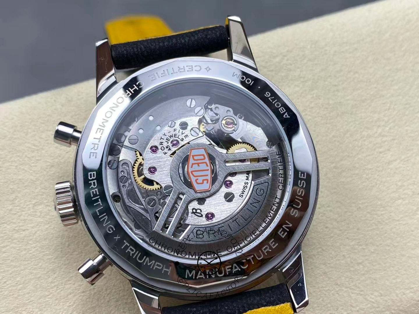 Transparent caseback showing movement and Deus logo on Breitling Top Time B01 AB01765A1B1X1.