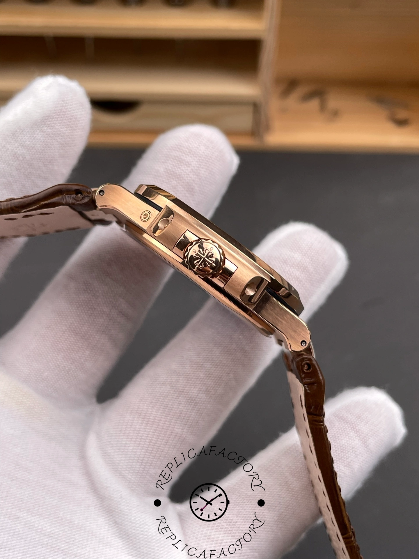 Side view of Patek Philippe Nautilus 5724/001 showing crown with Calatrava cross emblem.