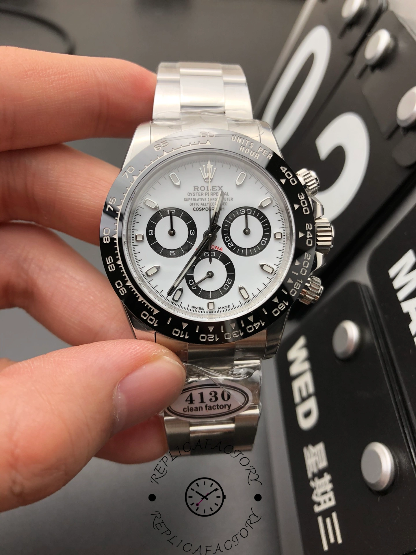 Front view of Rolex Cosmograph Daytona 116500LN-0001 with white dial, black ceramic bezel, and Oyster bracelet.