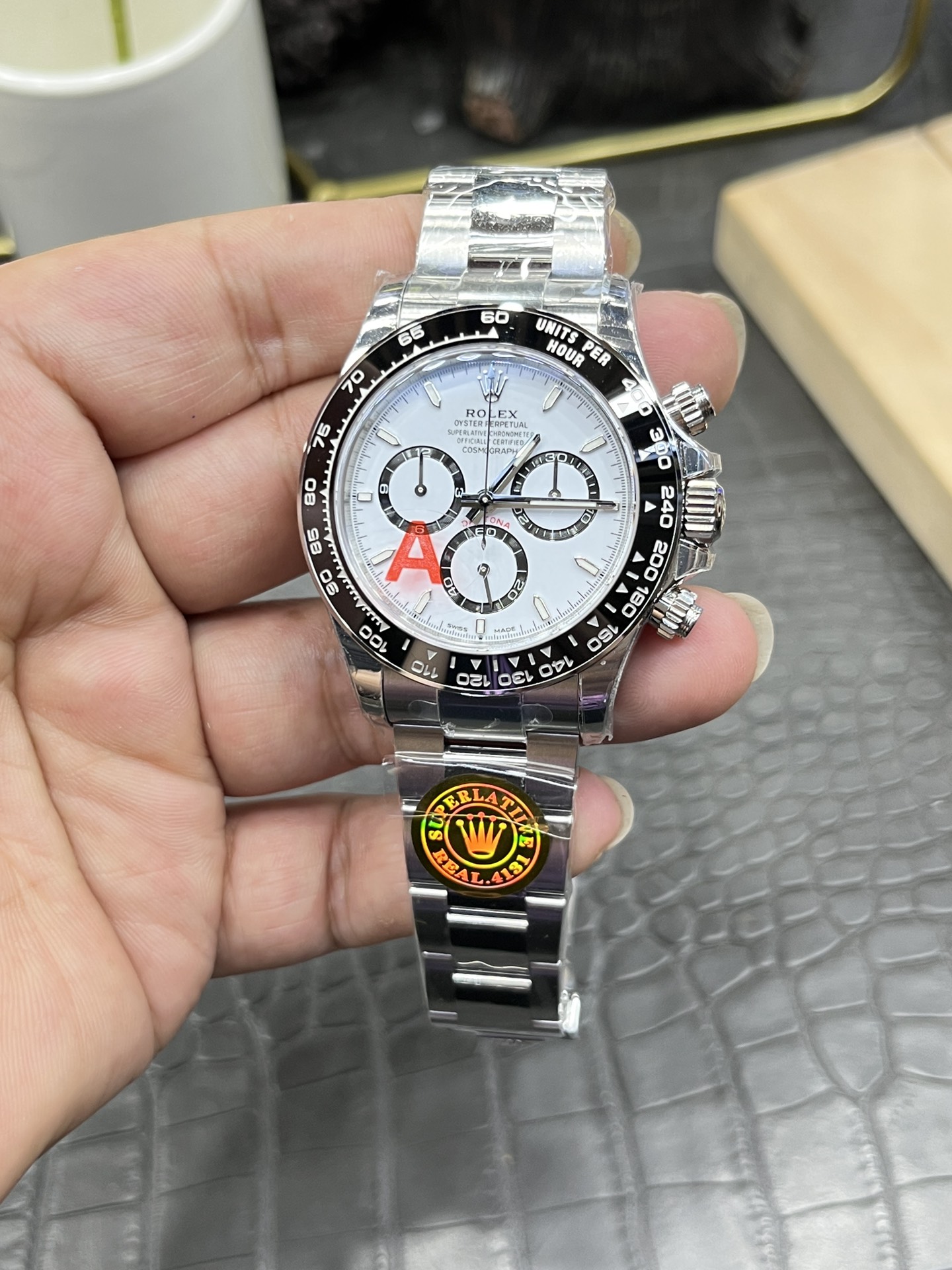 Front view of the Rolex Cosmograph Daytona M126500LN showing the white dial, black bezel, and 