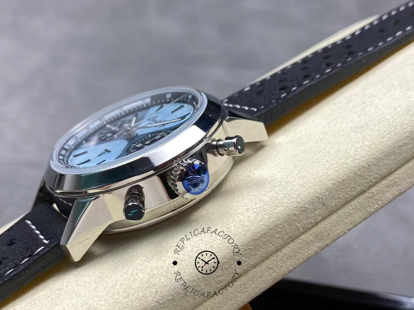 Crown side of Breitling Top Time Triumph A23311121C1X1 showing pushers and blue crown.