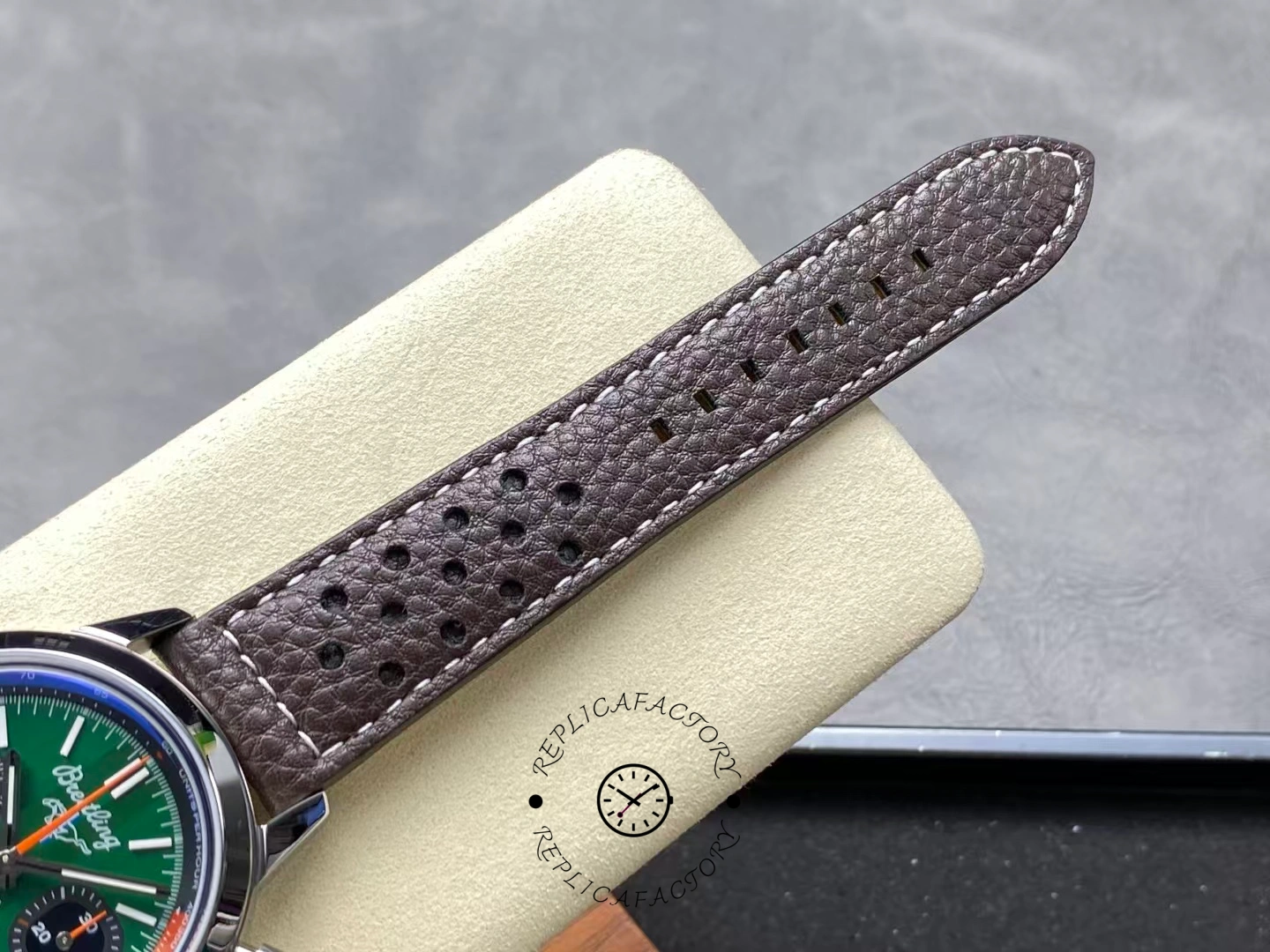 Brown perforated leather strap of Breitling Top Time B01 AB01762A1L1X1 close-up.
