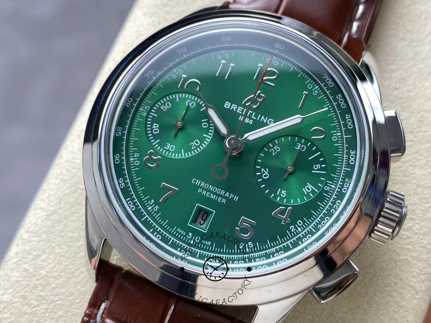 Close-up of Breitling Premier B01 Chronograph 42 AB0145371L1P1 green dial with brown strap.