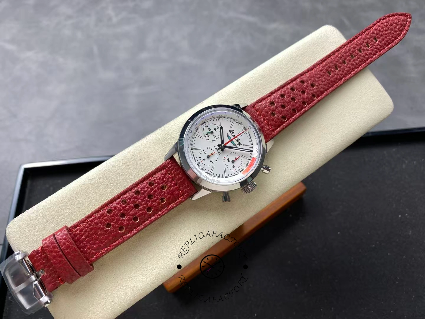 Full view of Breitling Premier B01 AB0176A71A1X1 white dial watch with red strap.