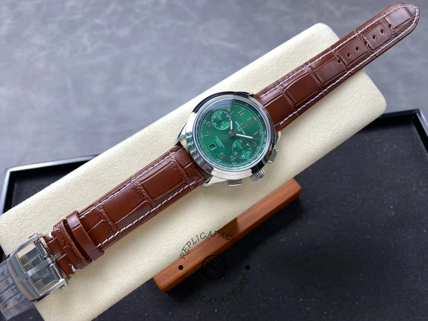 Full view of Breitling Premier B01 AB0145371L1P1 green dial chronograph with brown strap.