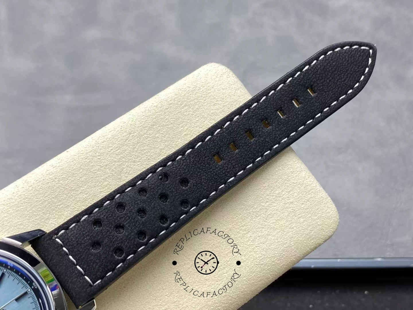 Perforated black leather strap of Breitling Top Time Triumph A23311121C1X1 close-up.