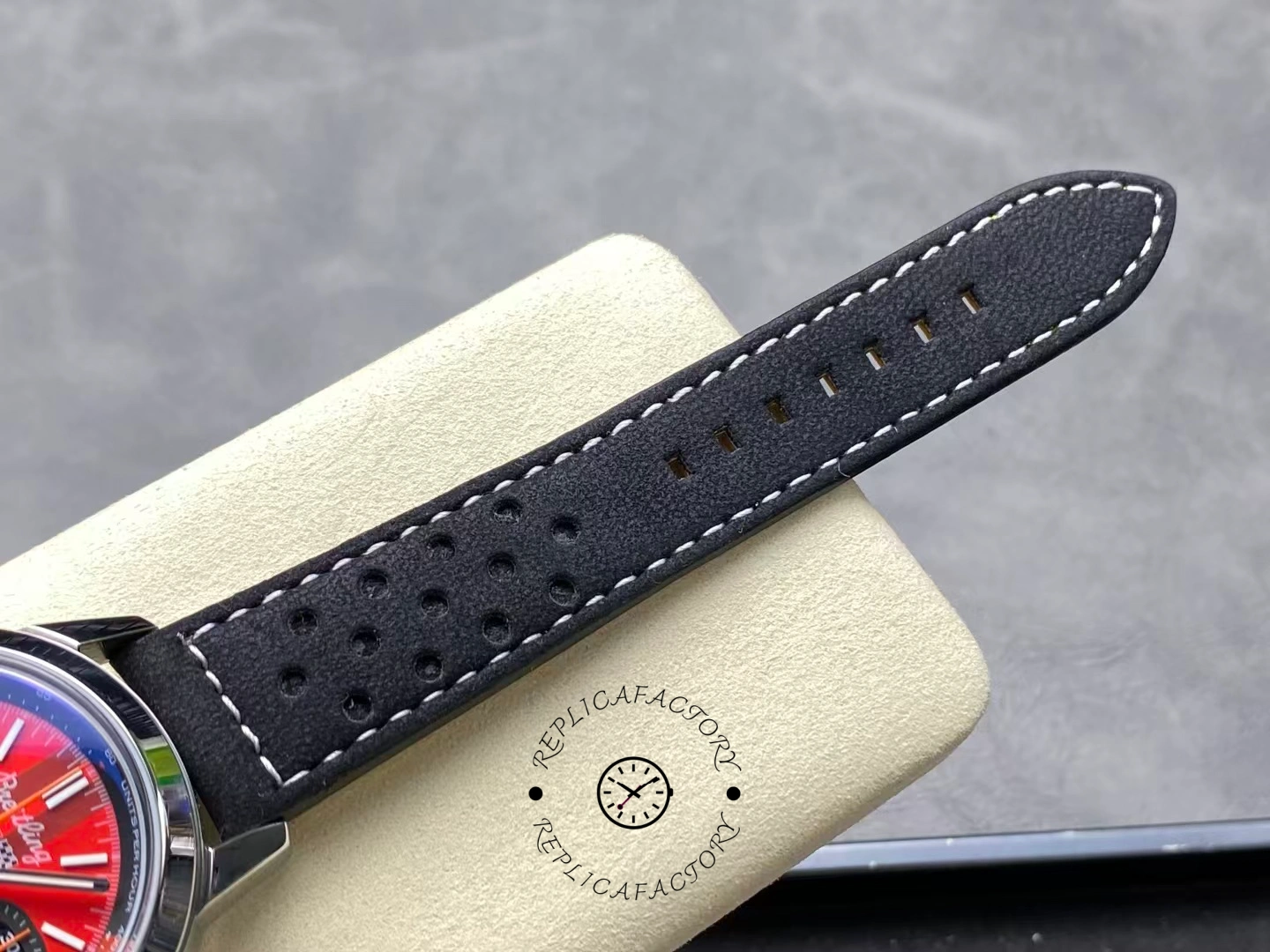 Perforated black leather strap of Breitling Top Time B01 Chevrolet Corvette AB01761A1K1X1 close-up.