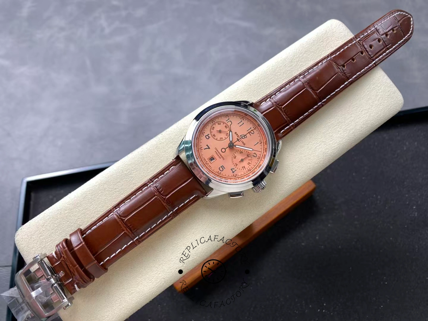 Full view of Breitling Premier B01 AB0145331K1P2 copper dial chronograph with brown strap.