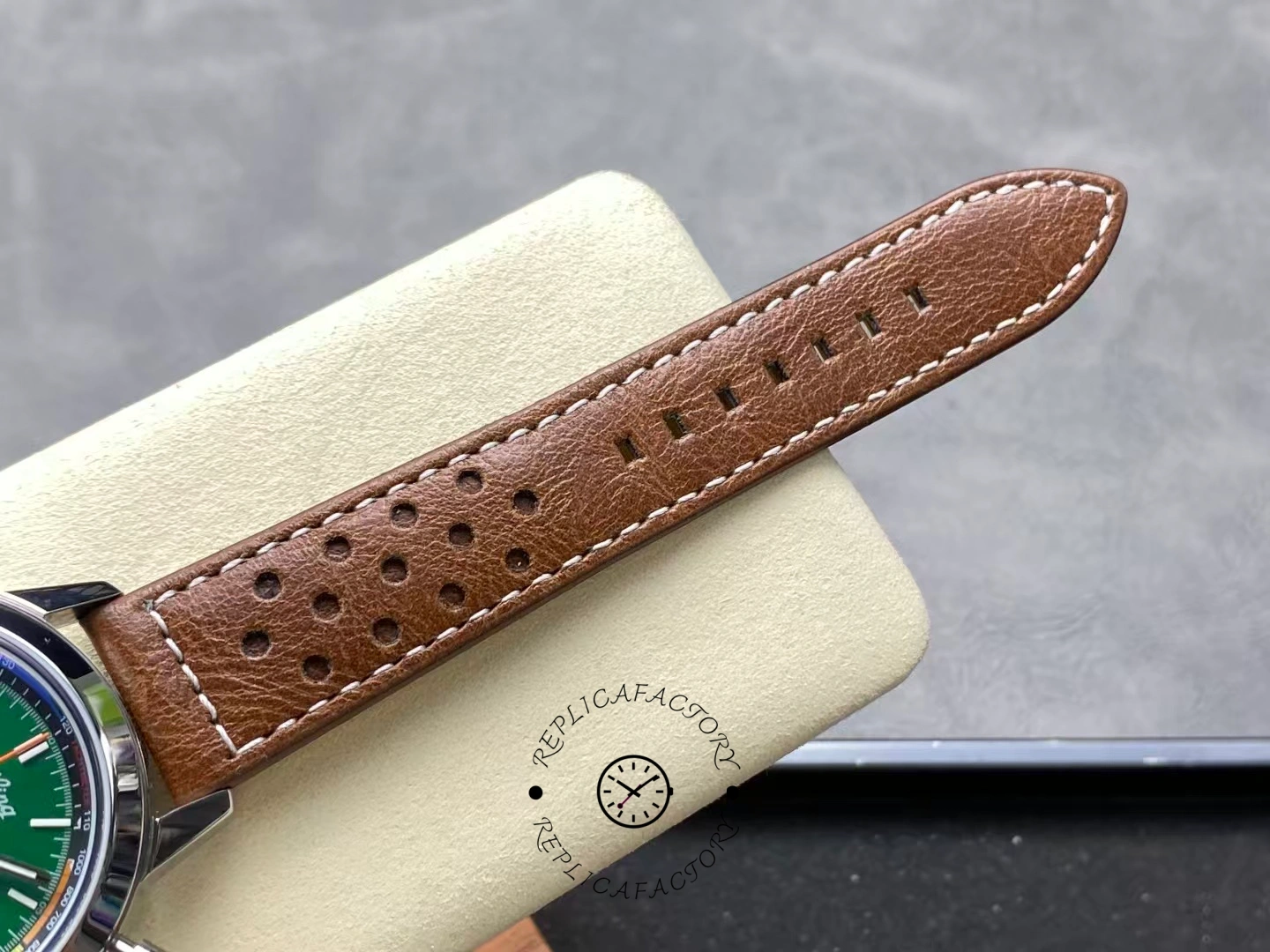 Brown perforated leather strap of Breitling Top Time Ford Mustang A253101A1L1X1 close-up.