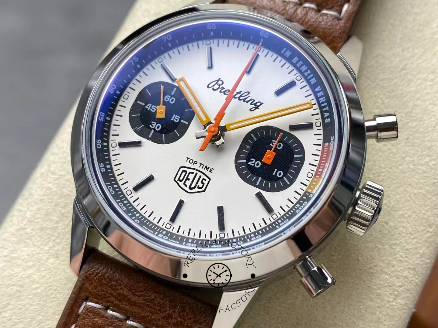 Close-up of Breitling Top Time Deus A233101A1A1X1 white dial with orange hands.