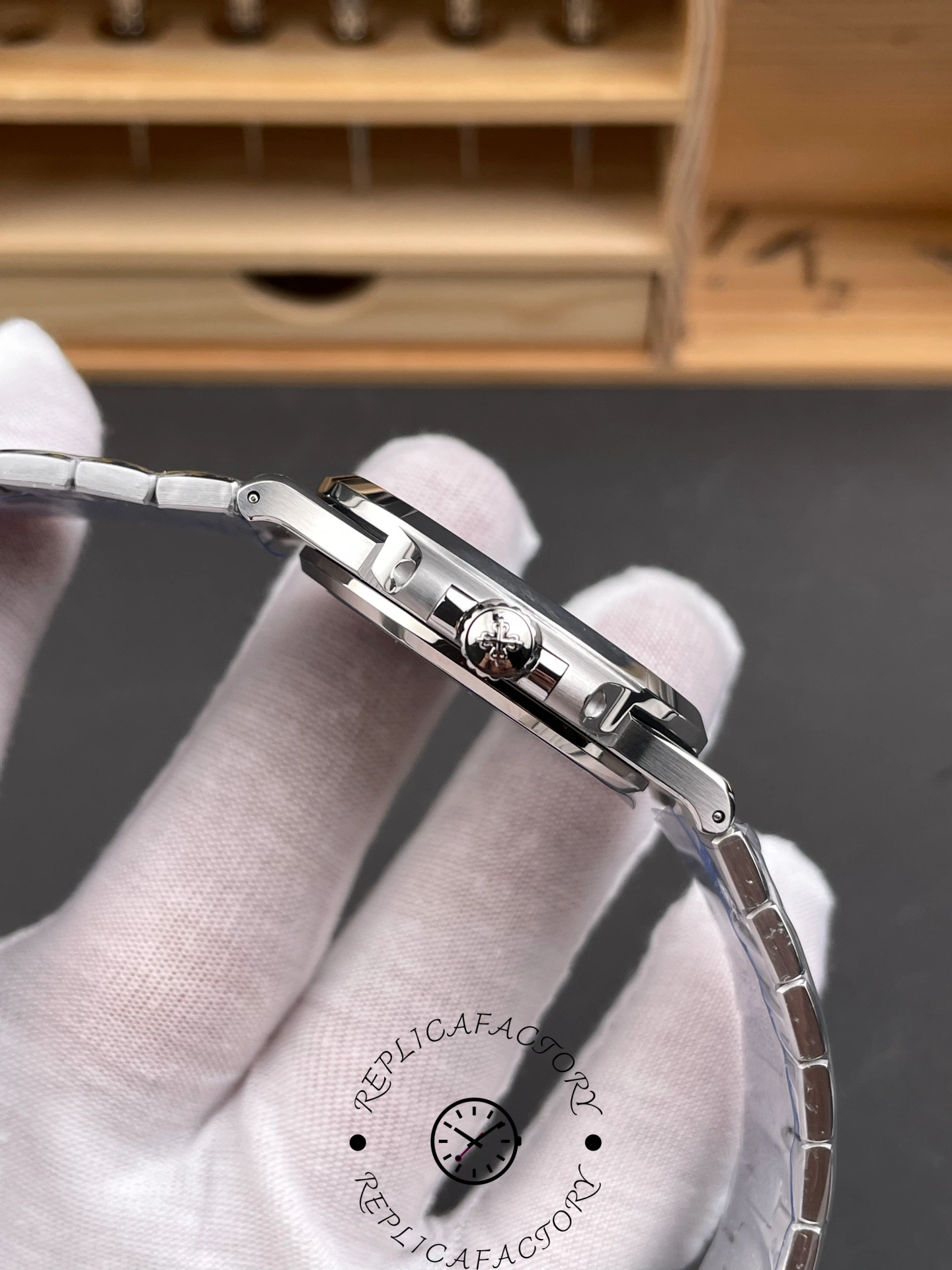 Side view of Patek Philippe Nautilus 5811/1G-001 with crown featuring Calatrava cross.