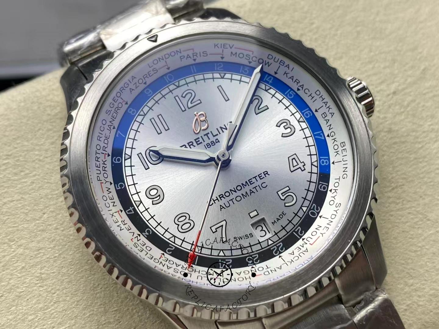 Angled view of Breitling Aviator 8 B35 AB3521U01G1A1 highlighting luminous numerals and red GMT hand.