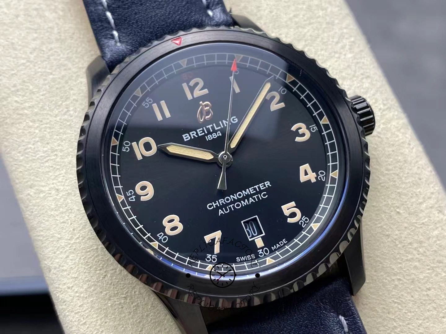 Close-up of Breitling Navitimer Aviator 8 M17314101B1X1 showing vintage beige numerals on black dial.