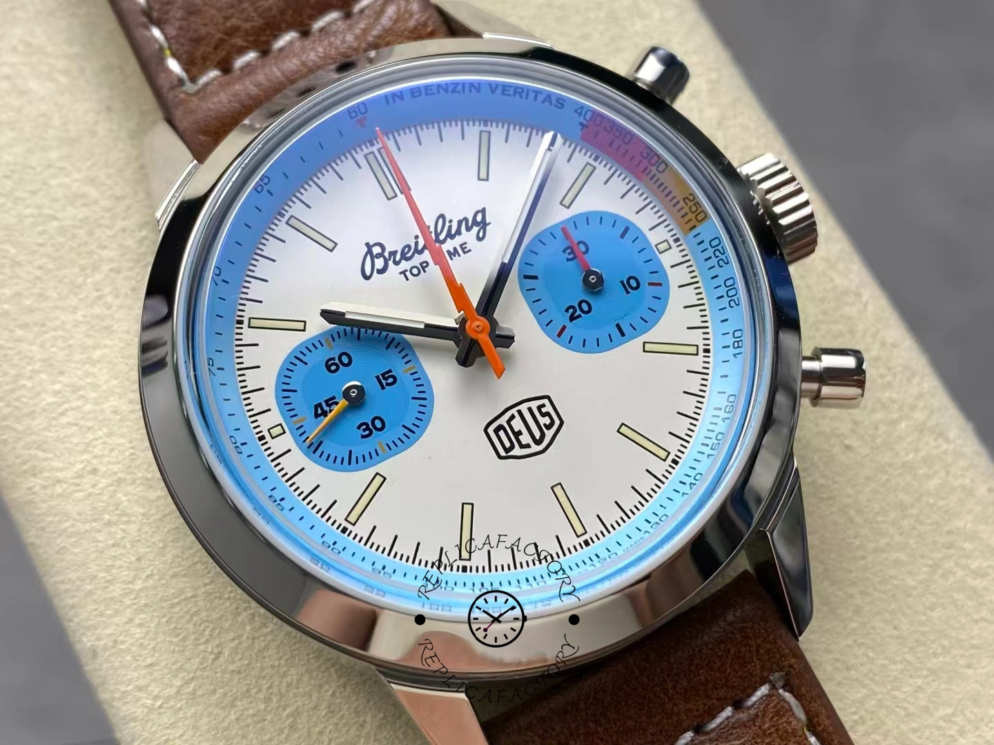 Detailed view of Breitling Top Time Deus A233112A1A1X1 showing orange hands.