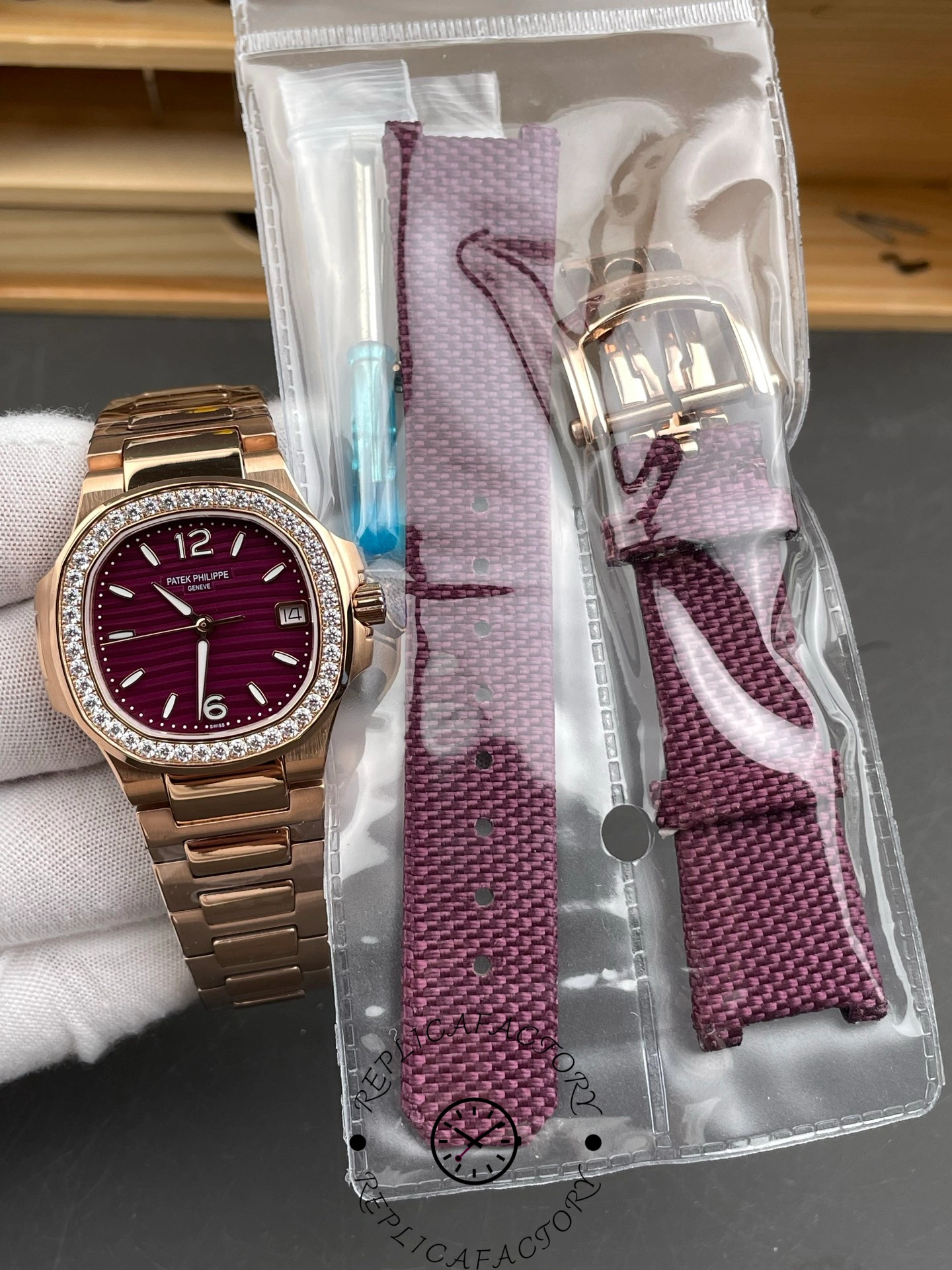 Patek Philippe Nautilus 7010/1R-013 with extra purple fabric strap and tools.