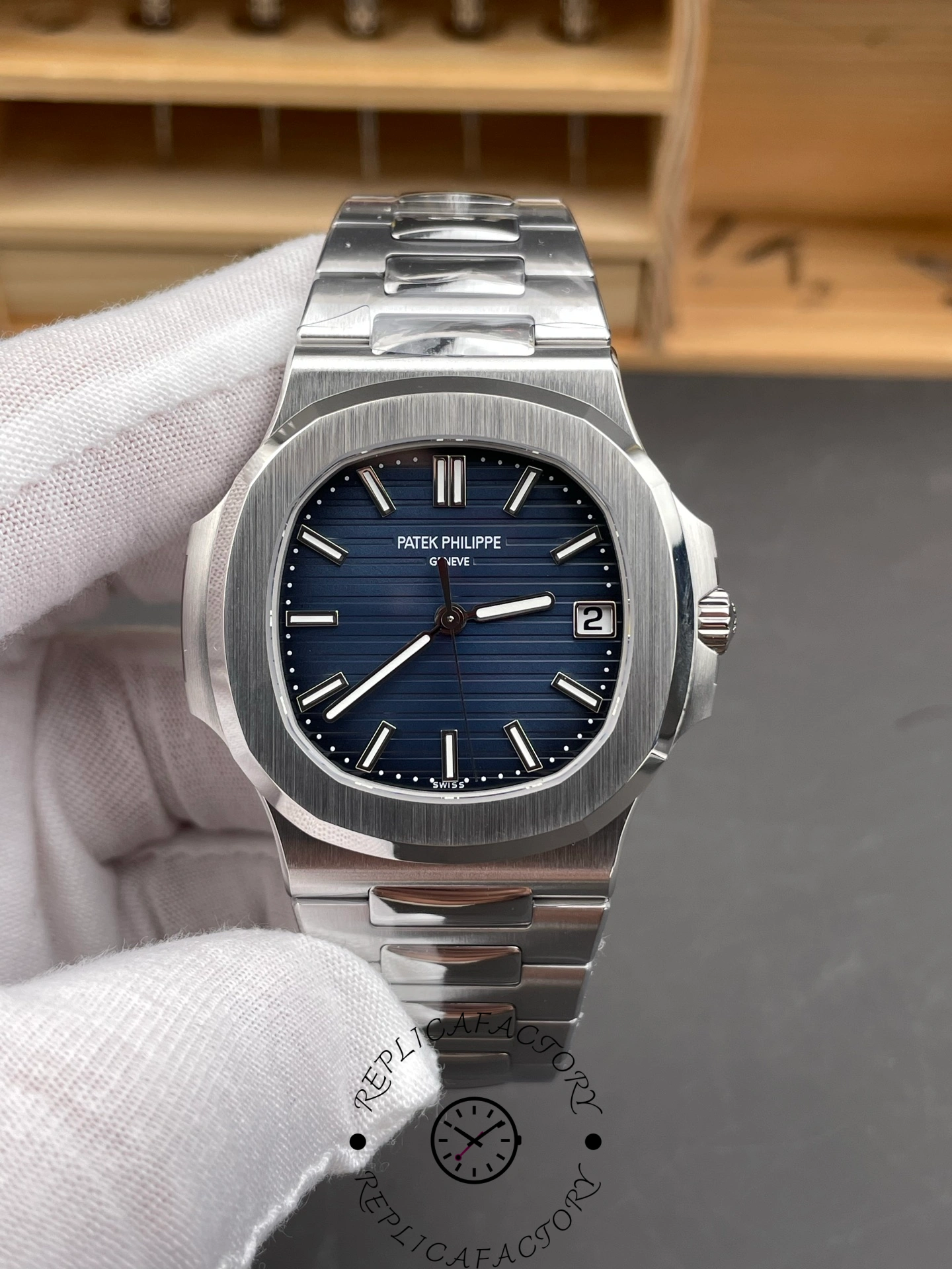 Handheld view of Patek Philippe Nautilus 5811/1G-001 highlighting brushed steel texture.