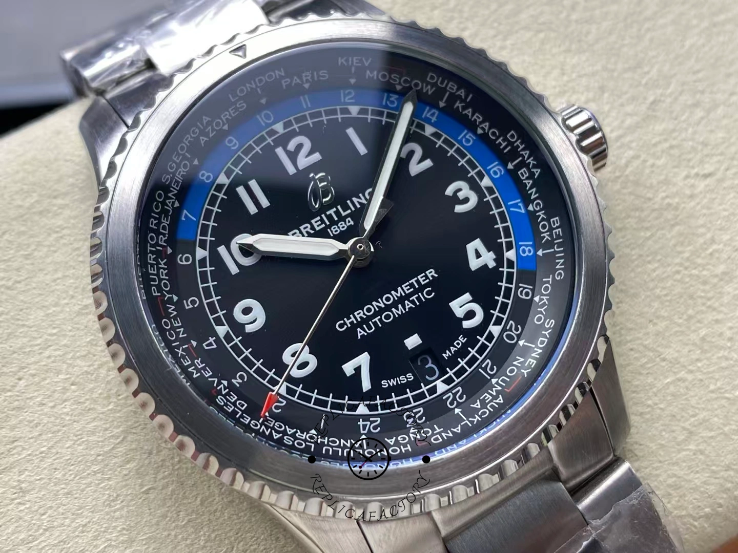Angled close view of Breitling Aviator 8 B35 AB3521U41B1A1 highlighting luminous numerals and red GMT hand.