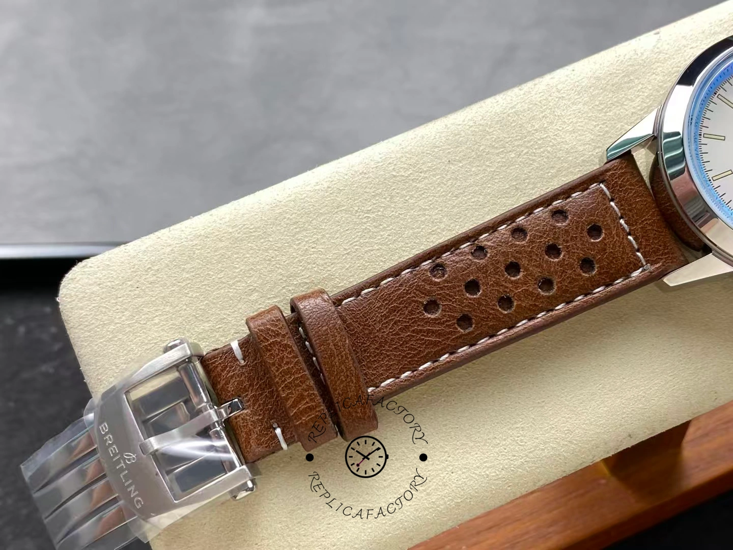 Buckle detail of Breitling Top Time Deus A233112A1A1X1 with engraved logo.