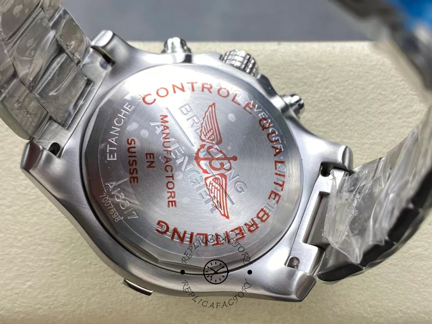 Caseback of Breitling Avenger Chronograph 45 A13317101B1A1 engraved with red quality control text.