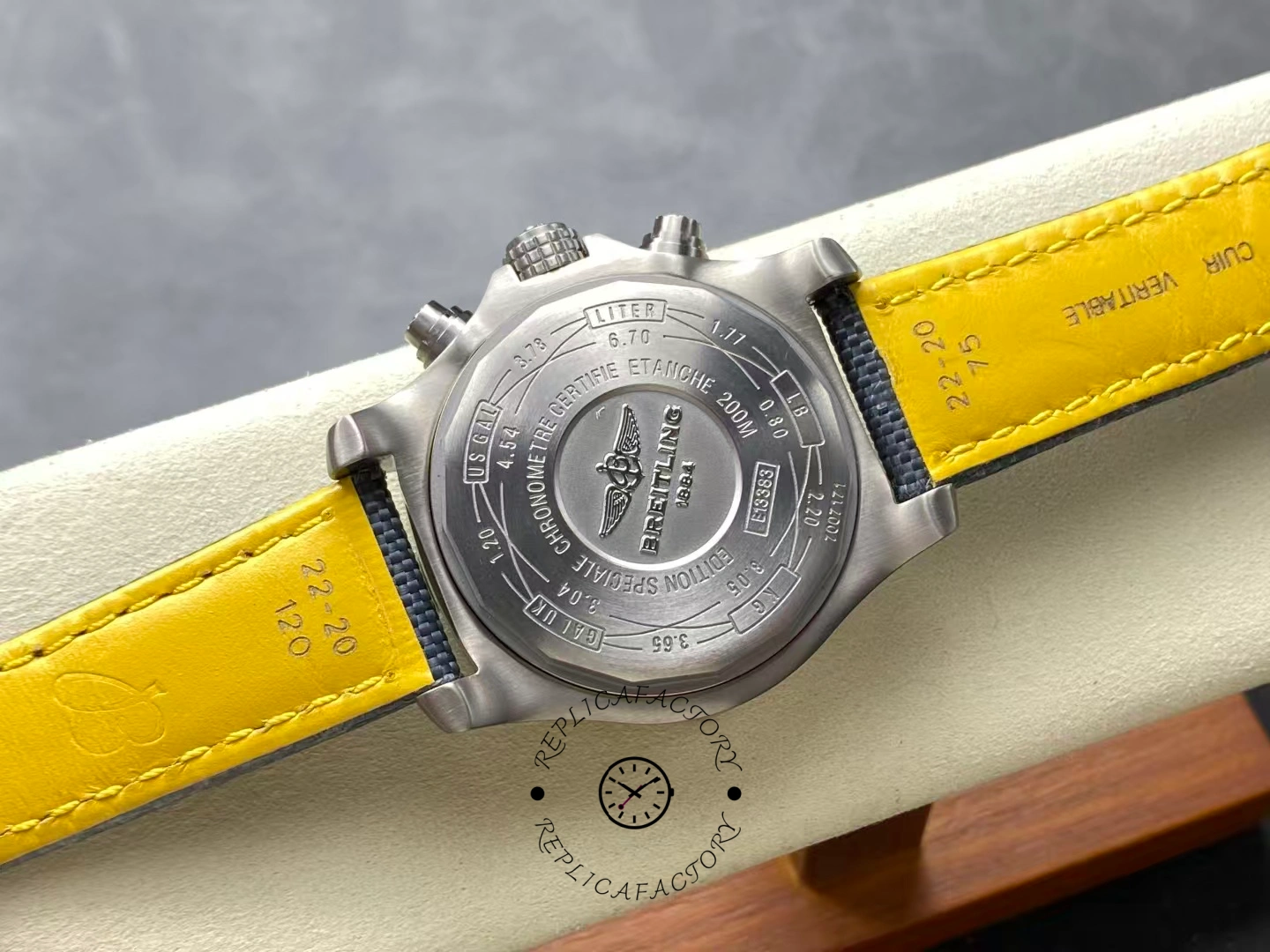 Caseback of Breitling Avenger Bandit E13383101M1W1 with engraved logo and yellow lining strap.