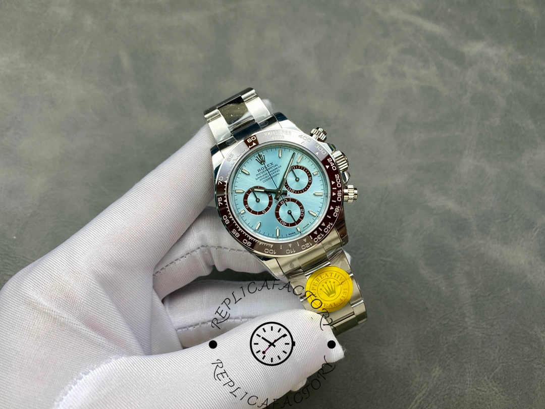 Full watch view of the Rolex Daytona 126506 held in hand, showing ice-blue dial and bracelet.