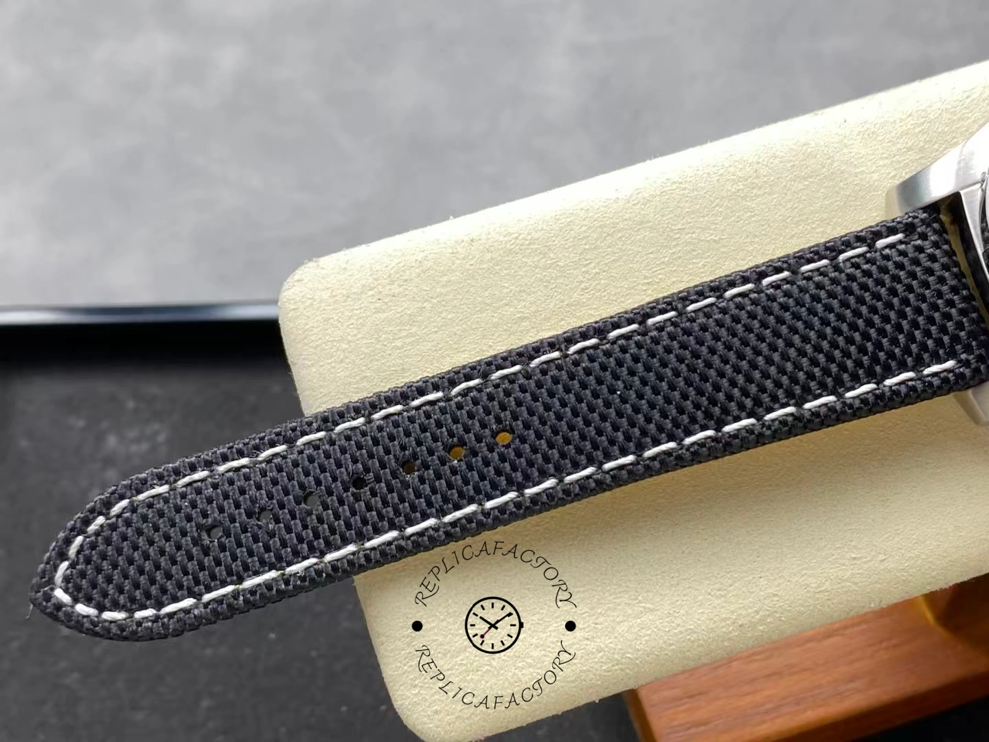Black fabric strap of Breitling Avenger Chronograph 45 A13317101B1X1 showing texture and stitches.