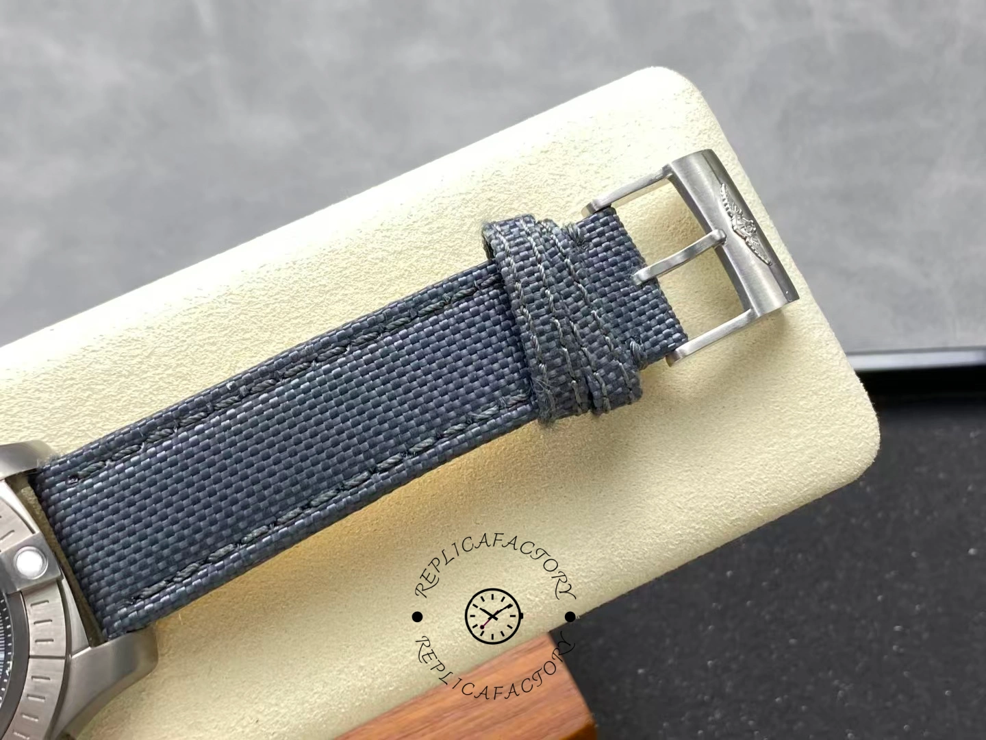 Fabric strap and buckle detail of Breitling Avenger Bandit E13383101M1W1 with brushed clasp logo.