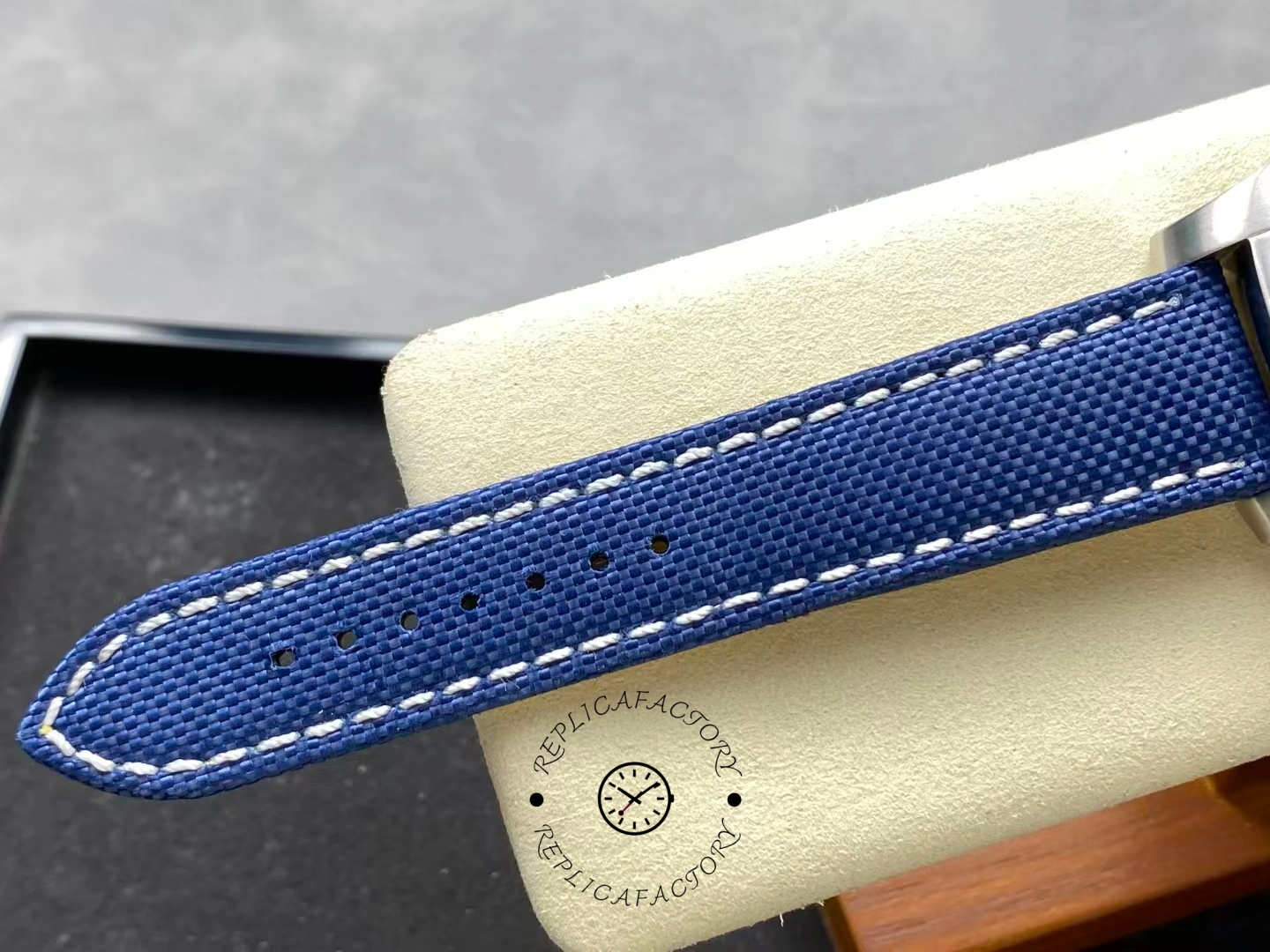 Blue fabric strap of Breitling Avenger Chronograph 45 A13317101C1X1 showing stitch detail.