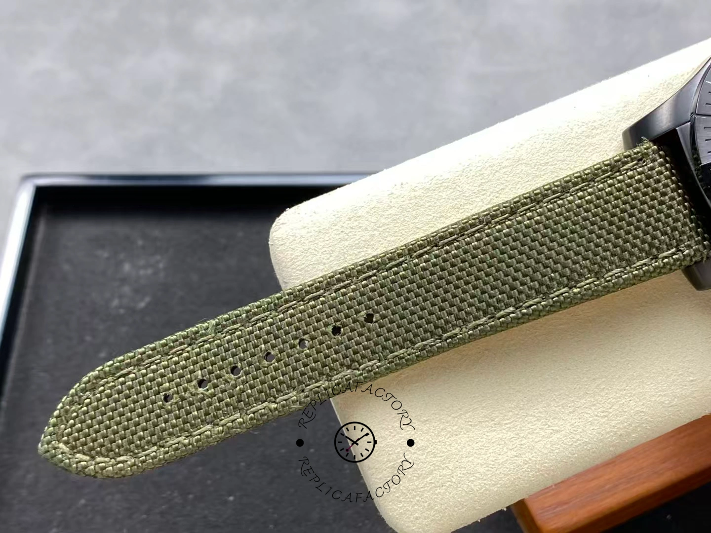 Green fabric strap of Breitling Avenger Chronograph 45MM V13317101L1X1 showing texture detail.