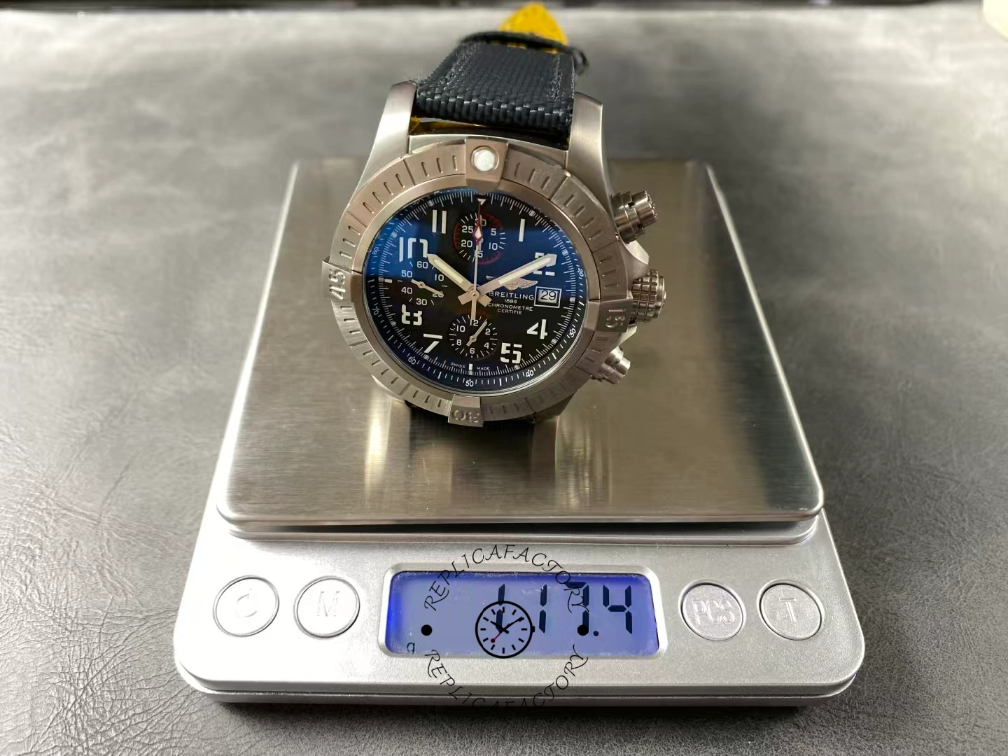Breitling Avenger Bandit E13383101M1W1 placed on scale showing 117.4g total weight.