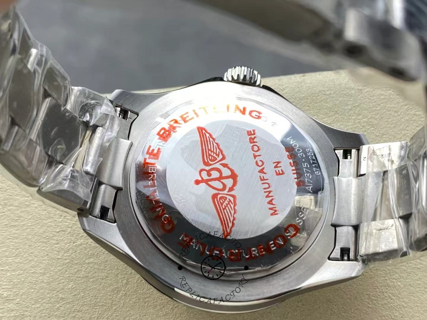 Caseback of Breitling Superocean 42 A173751A1O1S1 with red logo engraving.