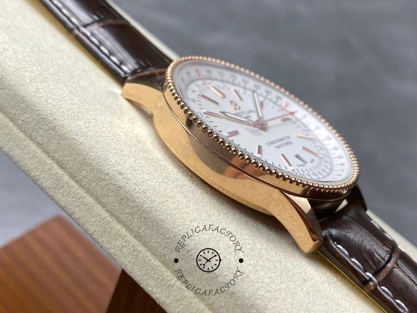 Left side of Breitling Navitimer 41 R17326211G1P1 showing polished rose gold case.